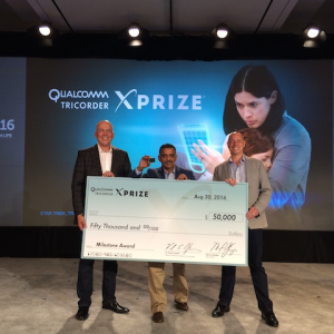  American Megatrends India's representative Sam (holding VitalsFit, AMI tricorder) received the cheque from QTXP team on behalf of AMI and Team Danvantri 